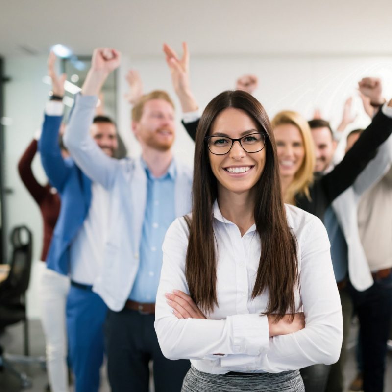 Mental Health. An image of a group of employees smiling at the camera and celebrating