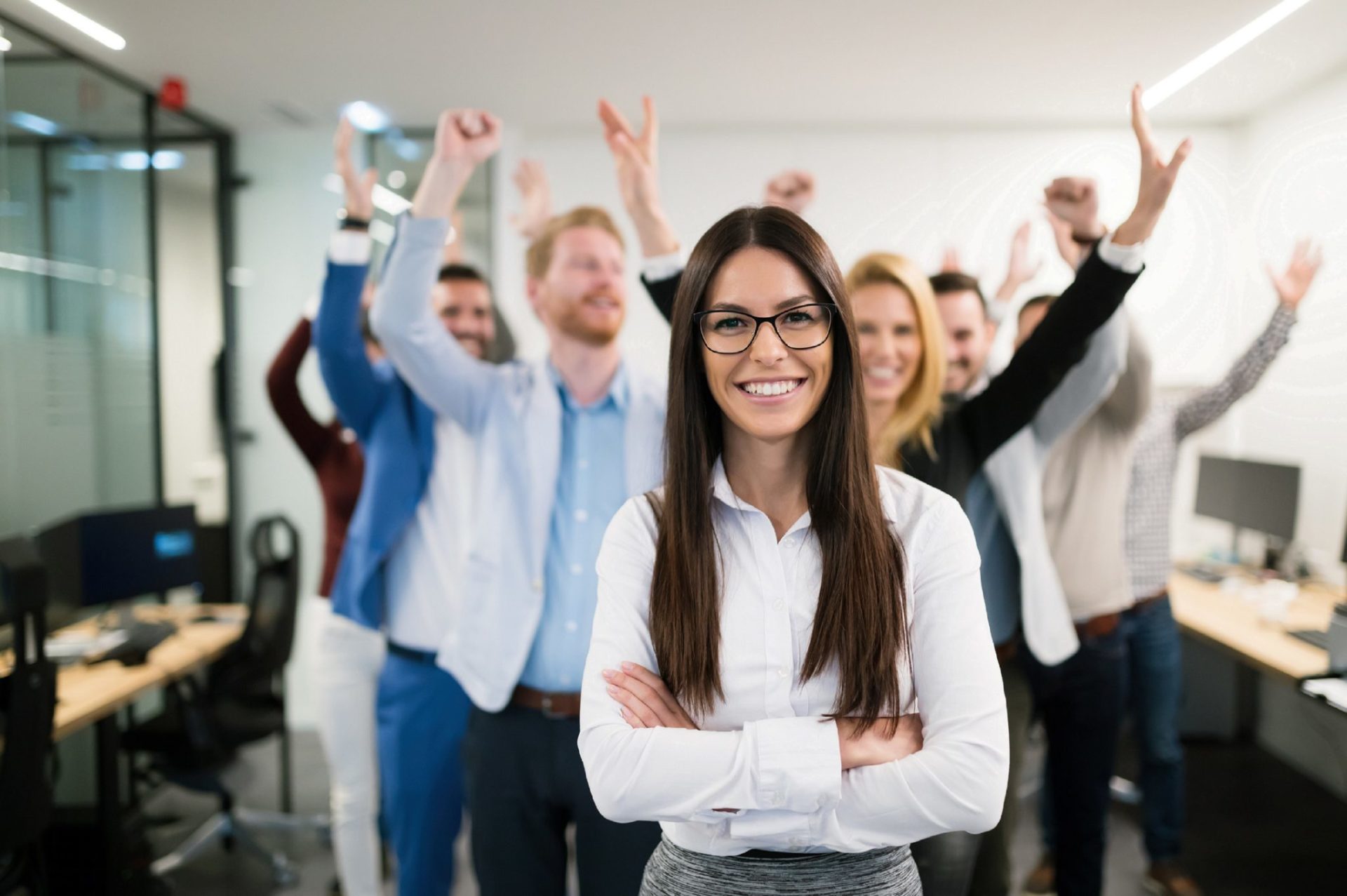 Mental Health. An image of a group of employees smiling at the camera and celebrating