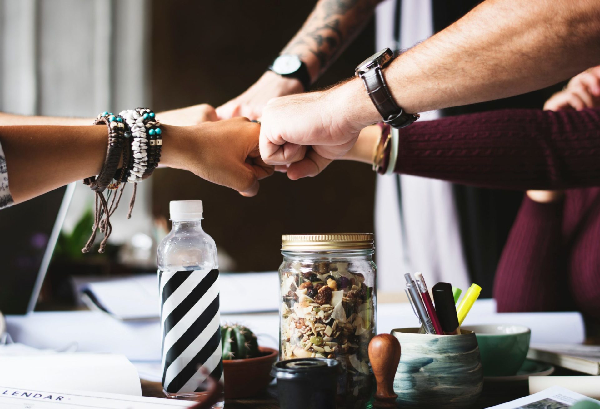 Diversity. Header Image for Blog. A stock image of 4 people touching fists